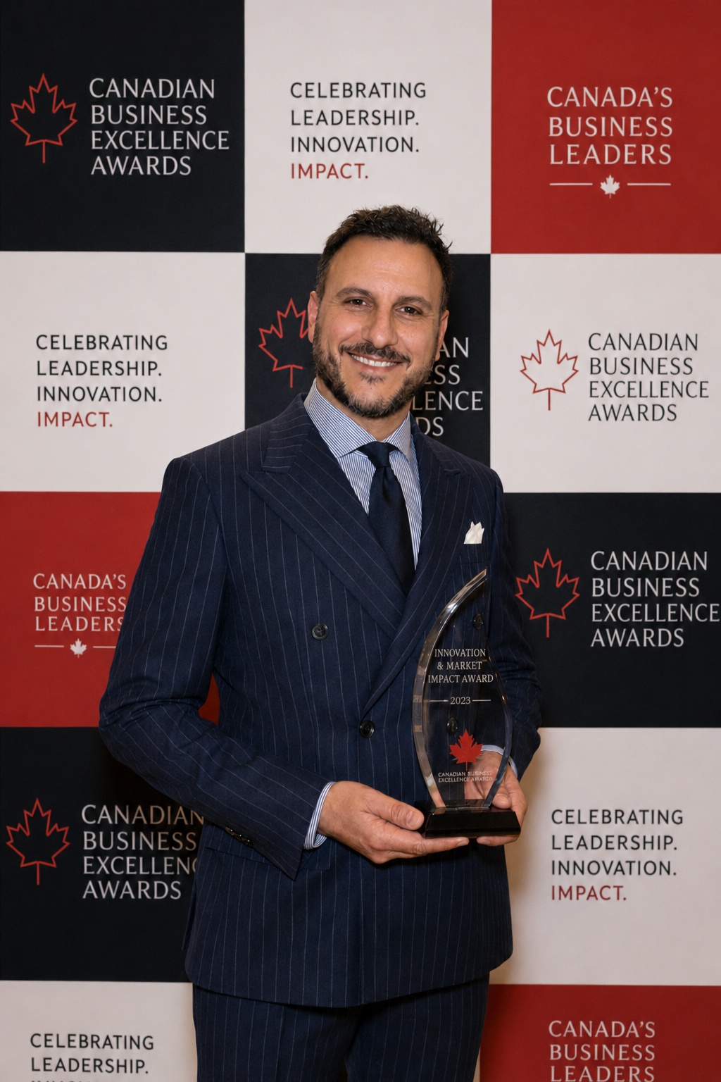 Ioannis Athanasiou holding his award at the Canadian Business Excellence Awards